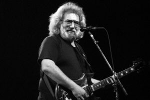 Jerry Garcia of the Grateful Dead playing guitar onstage