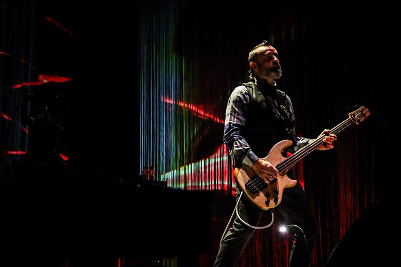 Justin Chancellor Playing one of the Types of Bass Guitars