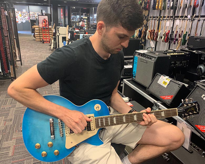 Me playing a blue Epiphone Les Paul